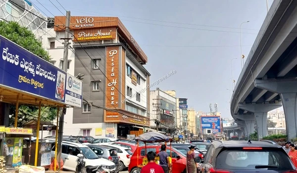Pista House & Dining Busy street view featuring the famous Pista House and Veto Bar & Kitchen near the flyover accessible from Prestige Golden Grove
