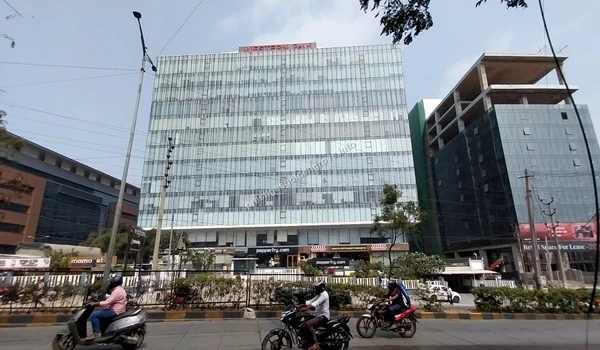 Western Pearl Retail The sleek glass facade of Western Pearl in Hyderabad featuring prominent retail brands like Pepperfry located in close proximity to the Prestige Golden Grove community